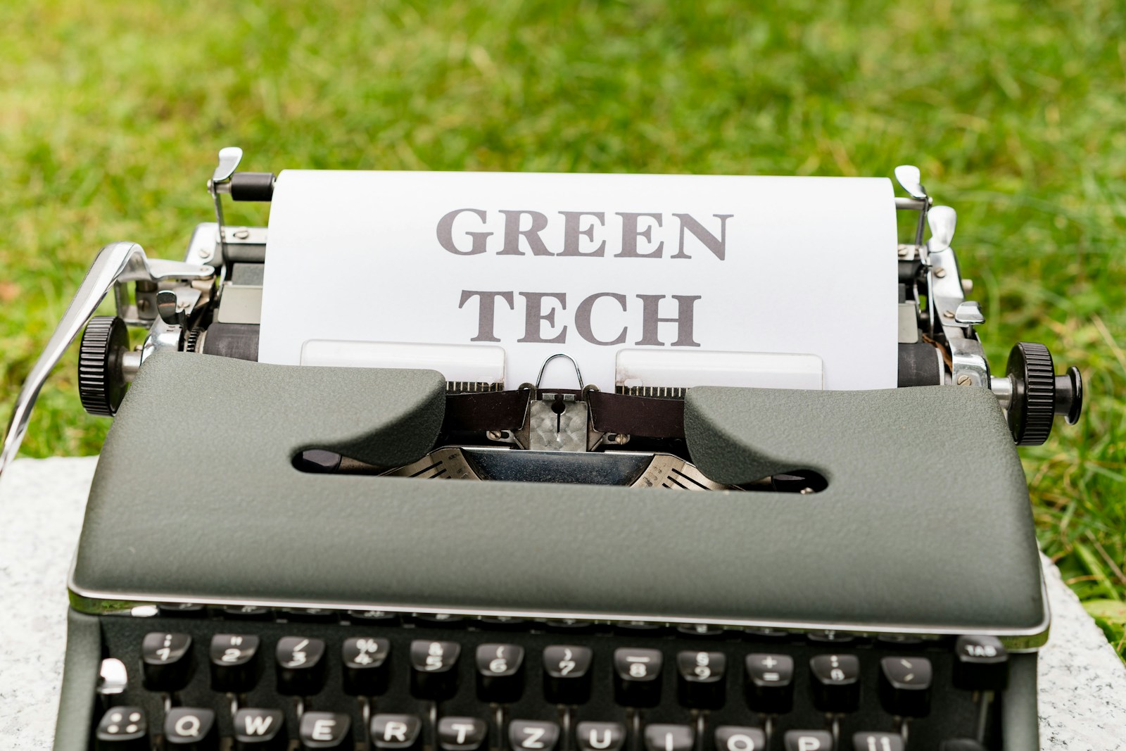 a green tech typewriter sitting on top of a table